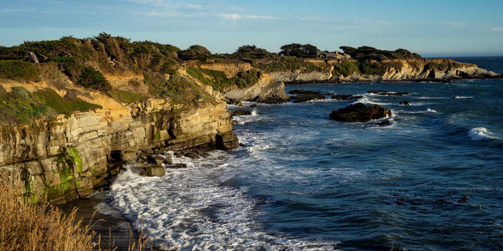 View of rocky coastline with crashing waves from Bluff Top Trail