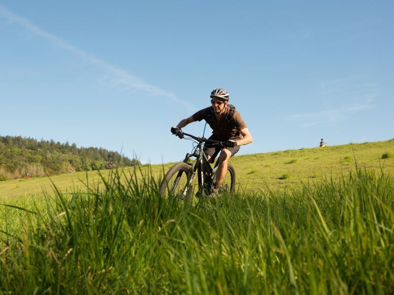 mountain biker rides down trail at Spring Lake Regional Park