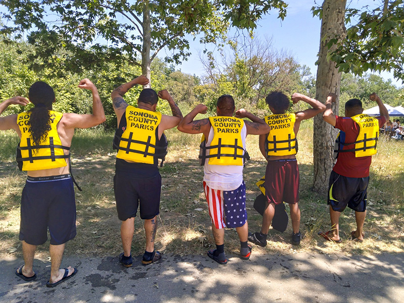 group of men wearing yellow life jackets