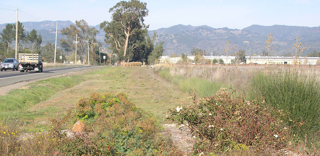 Looking north at former railroad right of way along 8th Street East