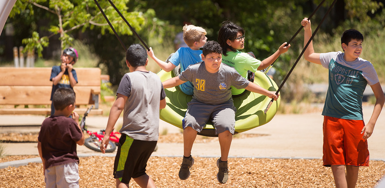 Youth on the playground at Andy's Unity Park