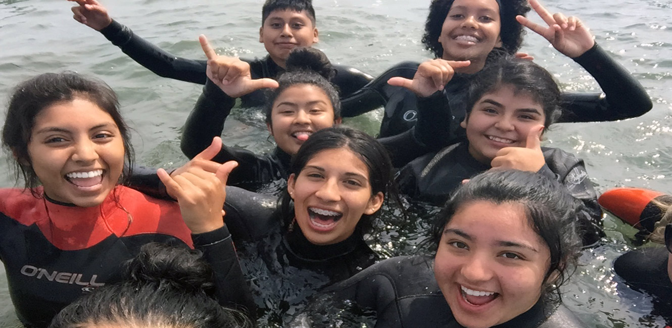 Youth swimming in the ocean as part of the YES! Coast program