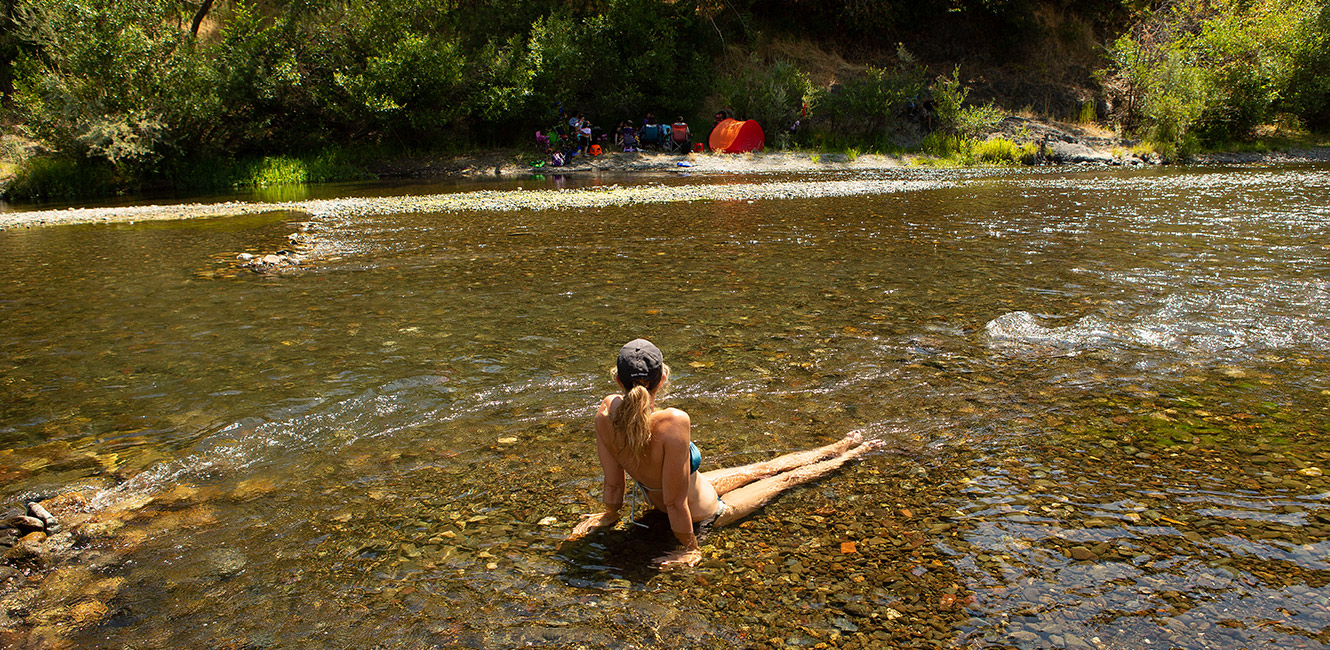 Sunbather in the Russian River at Del Rio Woods